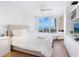 Spacious main bedroom with water views and built-in shelving at 1211 Gulf Of Mexico Dr # 301, Longboat Key, FL 34228