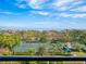 Elevated view of tennis courts with water and city views at 1211 Gulf Of Mexico Dr # 301, Longboat Key, FL 34228