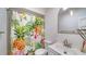 Clean bathroom with a tropical shower curtain and updated vanity at 1411 Quail Dr, Sarasota, FL 34231