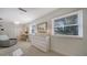 Well-lit bedroom with dresser and window seating area at 1411 Quail Dr, Sarasota, FL 34231