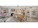 Bright dining room with wood table, fireplace, and kitchen view at 1411 Quail Dr, Sarasota, FL 34231