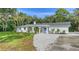 Newly renovated home exterior boasts a fresh white facade and landscaping at 1411 Quail Dr, Sarasota, FL 34231