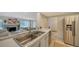 Kitchen sink and stainless steel appliances with a view to Gathering room at 1411 Quail Dr, Sarasota, FL 34231