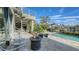 Outdoor oasis with pool, fire pit, and spiral staircase at 1560 Harbor Sound Dr, Longboat Key, FL 34228