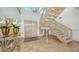 Grand two-story entry with elegant staircase and tile floors at 1560 Harbor Sound Dr, Longboat Key, FL 34228