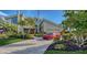 Luxury home with a red Corvette parked in the driveway at 1560 Harbor Sound Dr, Longboat Key, FL 34228