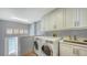 Laundry room with modern appliances and cabinets at 1560 Harbor Sound Dr, Longboat Key, FL 34228