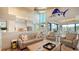 Open living room and kitchen with island and sunroom access at 1560 Harbor Sound Dr, Longboat Key, FL 34228