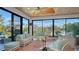 Relaxing sunroom with water views and wicker furniture at 1560 Harbor Sound Dr, Longboat Key, FL 34228