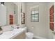 Stylish powder room with a floating vanity and contemporary decor at 16003 Kendleshire Ter, Lakewood Ranch, FL 34202