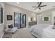 Relaxing bedroom with a comfy seating area and sliding door to the patio at 16003 Kendleshire Ter, Lakewood Ranch, FL 34202