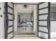 Open concept entryway with glass doors leading to living area at 16003 Kendleshire Ter, Lakewood Ranch, FL 34202