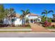 Bright, modern home with palm trees and a paver driveway at 16003 Kendleshire Ter, Lakewood Ranch, FL 34202