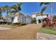 Modern home with a paver driveway and tropical landscaping at 16003 Kendleshire Ter, Lakewood Ranch, FL 34202