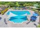 Lap pool with shade structures and lounge chairs at 16003 Kendleshire Ter, Lakewood Ranch, FL 34202