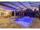 Inviting pool and spa area with a covered lanai and outdoor lighting at 16003 Kendleshire Ter, Lakewood Ranch, FL 34202