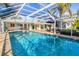 Inviting pool area with covered patio and lush landscaping at 1720 Anchorage St, Sarasota, FL 34231