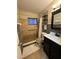 Clean bathroom with walk-in shower and dark vanity at 1832 Sunny Dr # D32, Bradenton, FL 34207