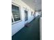 Building hallway with green floor and white walls at 1832 Sunny Dr # D32, Bradenton, FL 34207