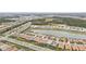 Aerial view of houses and a lake in a residential community at 20296 Bandera Pl, Venice, FL 34293