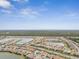 Aerial view of a community with houses, ponds, and lush greenery at 20296 Bandera Pl, Venice, FL 34293