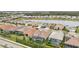 Aerial view of a community with lake, pool, and tennis courts at 20296 Bandera Pl, Venice, FL 34293