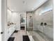Spa-like bathroom with double vanity, walk in shower, and bedroom view at 20296 Bandera Pl, Venice, FL 34293