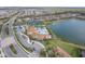 Aerial view of community pool, tennis courts, and lake at 20296 Bandera Pl, Venice, FL 34293
