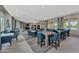 Community room with seating, tables, and large windows at 20296 Bandera Pl, Venice, FL 34293