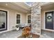 Cozy front porch with stone accents and seating area at 20296 Bandera Pl, Venice, FL 34293