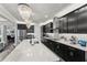 Modern kitchen featuring an expansive island and sleek cabinetry at 20296 Bandera Pl, Venice, FL 34293