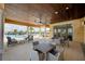 Community patio with tables and chairs near the pool at 20296 Bandera Pl, Venice, FL 34293