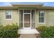 Front entrance with a screened porch and lush landscaping at 209 Fontanelle Cir, Venice, FL 34292