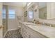 Updated bathroom with double vanity, marble countertop, and patterned floor at 2264 Floyd St, Sarasota, FL 34239