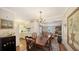 Dining room adjacent to kitchen with hardwood floors and chandelier at 2264 Floyd St, Sarasota, FL 34239