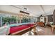 Covered patio with pool table and view of the pool at 2264 Floyd St, Sarasota, FL 34239