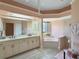 Elegant bathroom with double vanity, soaking tub, and separate shower at 25072 Palisade Rd, Punta Gorda, FL 33983