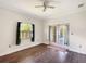 Well-lit bedroom featuring hardwood floors and double doors to the backyard at 25072 Palisade Rd, Punta Gorda, FL 33983