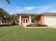 Attractive home with double doors and a neatly landscaped yard at 25072 Palisade Rd, Punta Gorda, FL 33983