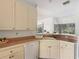 White kitchen cabinets and a corner sink at 25072 Palisade Rd, Punta Gorda, FL 33983