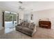 Bright living room features a comfy sofa, pool view, and a piano at 25072 Palisade Rd, Punta Gorda, FL 33983