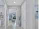 View down a hallway that leads to the living room at 26017 Seastone Dr, Englewood, FL 34223