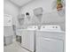 Laundry room with washer, dryer, and utility sink at 26017 Seastone Dr, Englewood, FL 34223