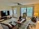 Bright and airy living room featuring a large TV at 2937 N Lockwood Meadows Blvd, Sarasota, FL 34234