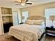 King-size bed and built-in shelving in main bedroom at 2937 N Lockwood Meadows Blvd, Sarasota, FL 34234