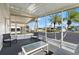 Relaxing screened porch with seating area, overlooking community at 312 Tropic Dr, Osprey, FL 34229