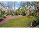 Brick patio, lush landscaping, and a kidney-shaped pool at 320 29Th Nw St, Bradenton, FL 34205