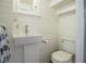 Small half bathroom with pedestal sink and white wood walls at 320 29Th Nw St, Bradenton, FL 34205