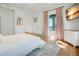 Bright bedroom with queen bed, hardwood floors, and water views at 320 29Th Nw St, Bradenton, FL 34205