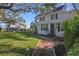 Two-story house with wrap around porch, mature landscaping and large yard at 320 29Th Nw St, Bradenton, FL 34205